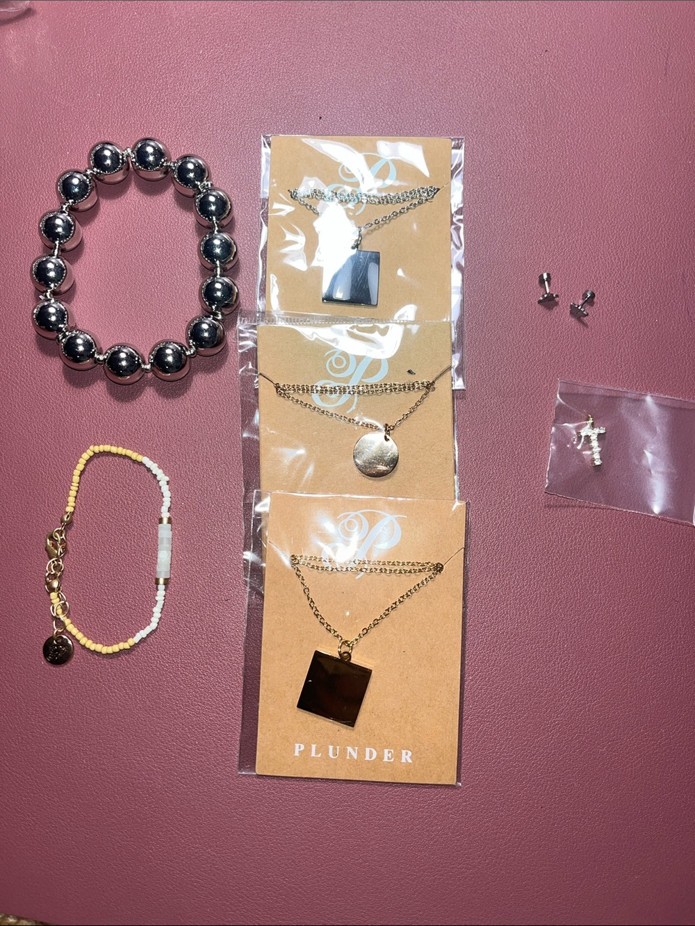 7 pc Plunder set three necklaces, two bracelets, pair of earrings, cross pendant